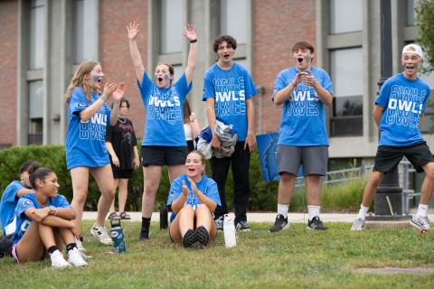 Students clap and cheer while wearing Westfield State blue t-shirts