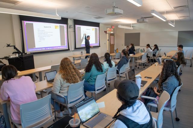 Faculty member giving a presentation in an education classroom.