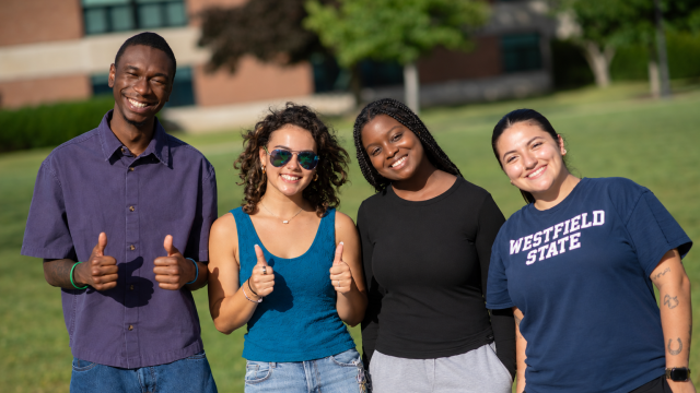 Student smiling together on campus green.